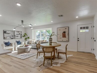 Dining area featuring visible vents, light wood-ty
