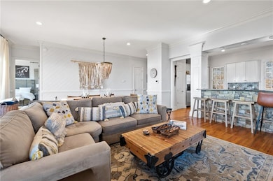 Living area featuring a notable chandelier, decora