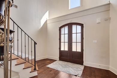 Entryway featuring arched walkways, a towering cei