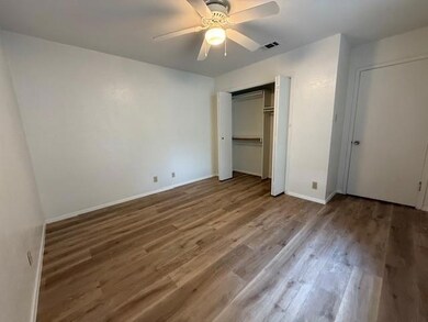 Unfurnished bedroom featuring light wood-style floors, a closet, and ceiling fan
