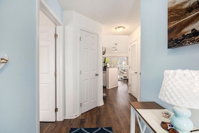 Hall with dark wood-type flooring