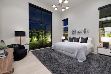 Bedroom featuring wood finished floors and a chand