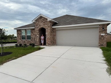 Ranch-style house featuring brick siding, drivewa