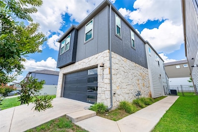 View of home's exterior featuring stone siding, a
