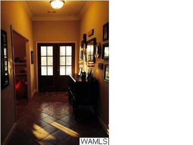 Spacious foyer features ceramic tile entry
