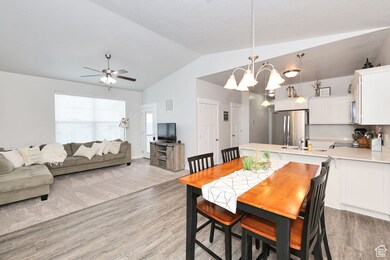 Vaulted, Open Spaces Great Room with Dining room and lofted ceiling
