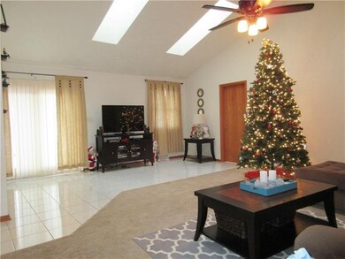 Living room: 2 skylights, sliding glass door leadi
