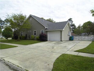 Photo. Exterior side view of garage, extra drivewa