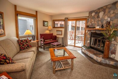 Living room with a fireplace, a textured ceiling, 