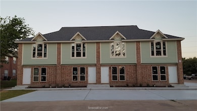 Traditional-style house with brick siding