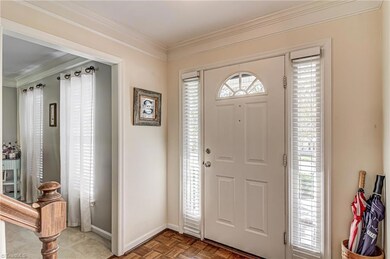 From the front door, enter into the front foyer. Beautiful front door with side lights lets in lovely natural light to the entry. Door way to the left leads into the living room.