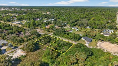 View of property location with property parcel outlined and a heavily wooded area
