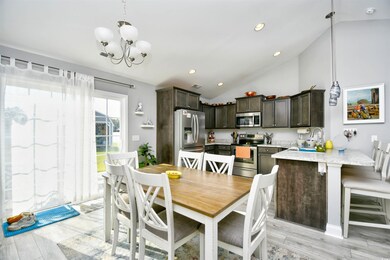 Dining area featuring high vaulted ceiling, sink, 