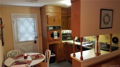 Kitchen With Door Leading Out To Screened Porch