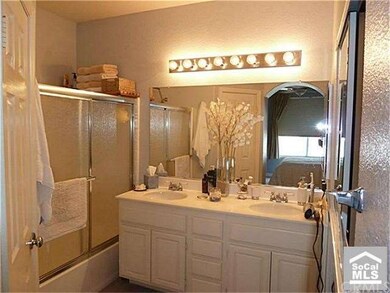Master bathroom with tile floors, dual sinks, and 
