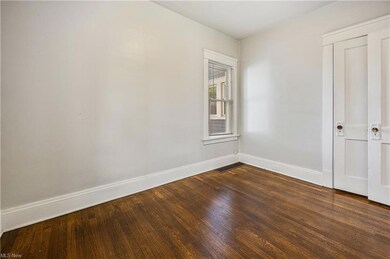 Spare room featuring dark hardwood floors