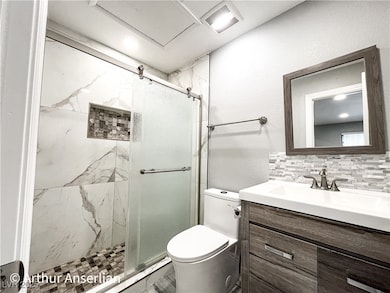 Bathroom featuring visible vents, toilet, and a st