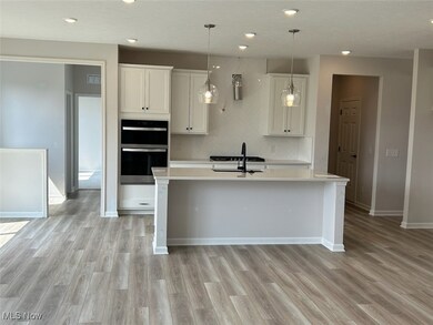 Upgraded white cabinetry, quartz countertops and built-in appliances included in the kitchen.
