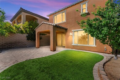 Back of house with a patio, a tile roof, and stucc