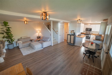 Living area with updated Pergo flooring updated light fixtures, new paint,