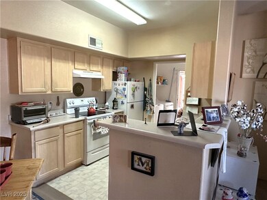Kitchen featuring light floors, light countertops,