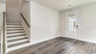 Entrance foyer featuring stairway, wood finished f
