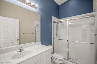 Bathroom featuring toilet, a stall shower, and van