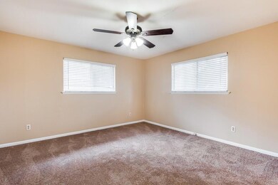 Carpeted empty room featuring baseboards and a ce