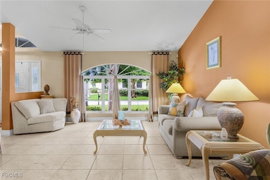 Living area featuring ceiling fan and tile patterned floors