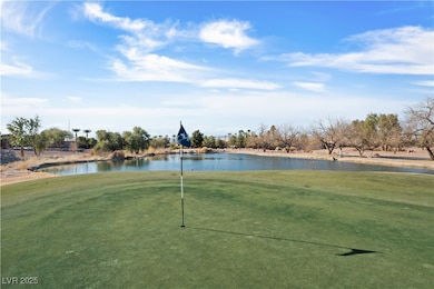View of home's community with a water view, a yard
