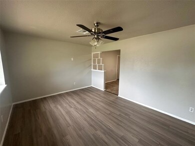 Unfurnished room with dark wood-style floors, ceil