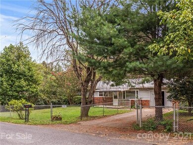 Mature trees line the fenced-in yard