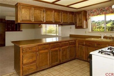 Kitchen opens to family room.  Original linoleum f