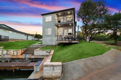 Back of house at dusk with a yard, stairway, a ba