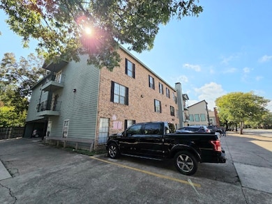 View of property with uncovered parking