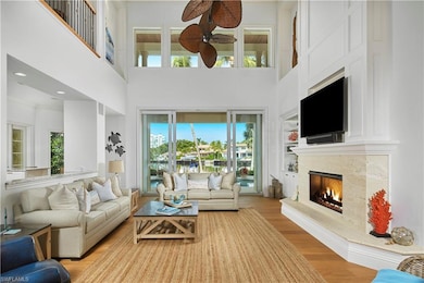 Living room with ceiling fan, a wealth of natural 