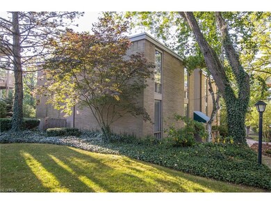 All brick building is nestled in the wooded ground