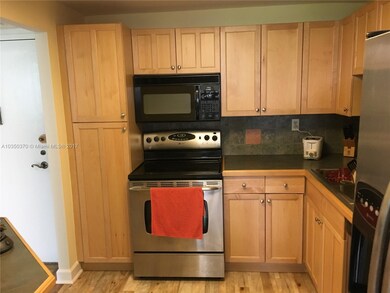 REMODELED KITCHEN WITH STAINLESS STEEL APPLIANCES.