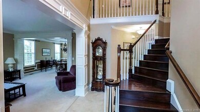 Beautiful 2 Story Foyer with custom molding and cu