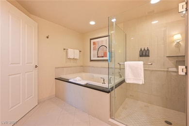 Bathroom with tile patterned floors, a stall showe