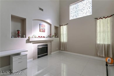 Living room featuring a fireplace, a towering ceil