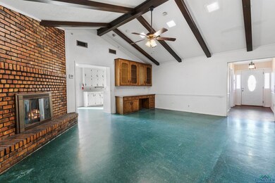 Unfurnished living room with a fireplace, high vau