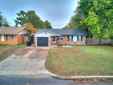 Ranch-style home with an attached garage, brick siding, and driveway