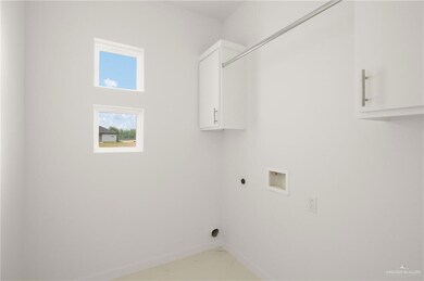 Laundry room with cabinet space, hookup for an electric dryer, baseboards, and hookup for a washing machine