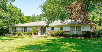 Ranch-style home featuring a front lawn