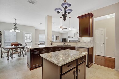 Alternate view of kitchen open to breakfast area and living room with convenient elevated bar seating.