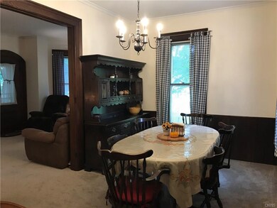 The kitchen leads to the dining room, which boasts