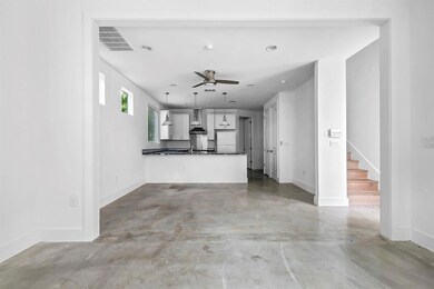 Unfurnished living room featuring concrete floori