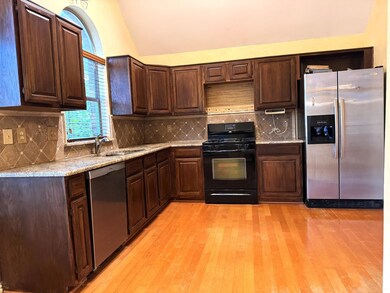 Kitchen featuring decorative backsplash, sink, sta