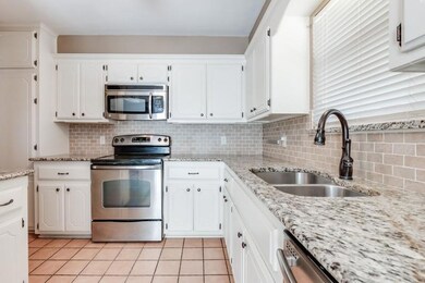 Kitchen featuring tasteful backsplash, appliances 